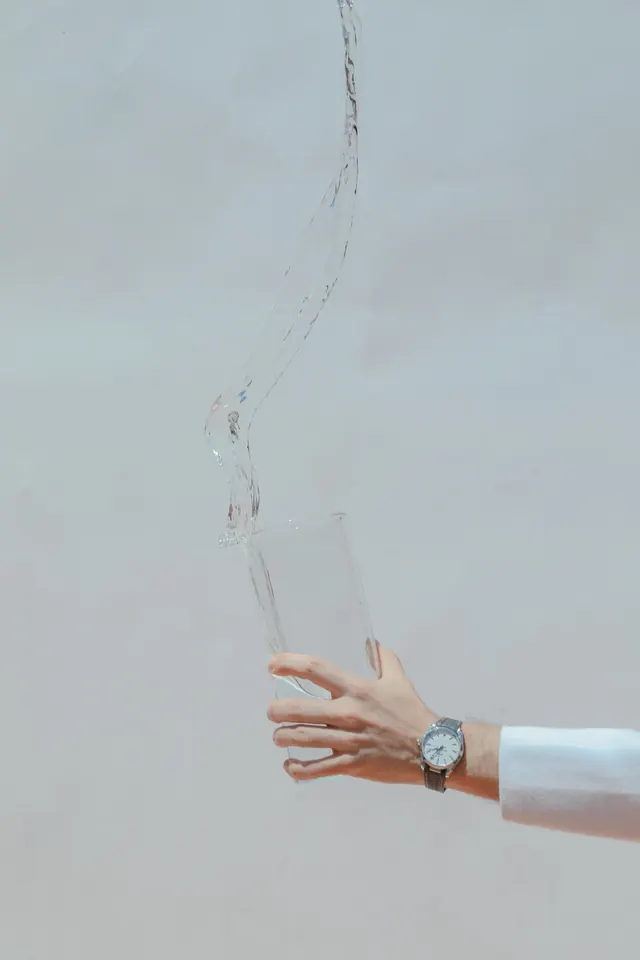 Hand Holding Transparent Glass
