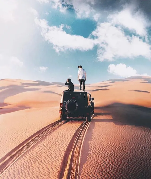 Person on Vintage Vehicle in Desert