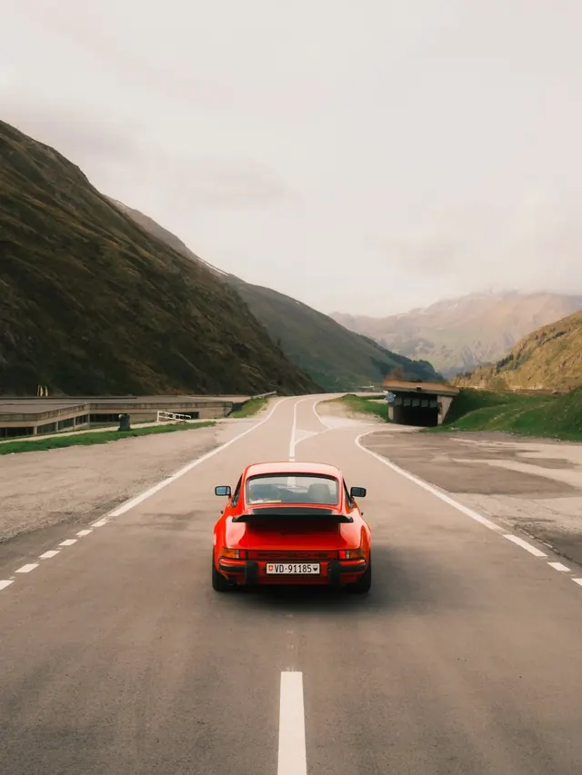 Red Sports Car on Mountain Road