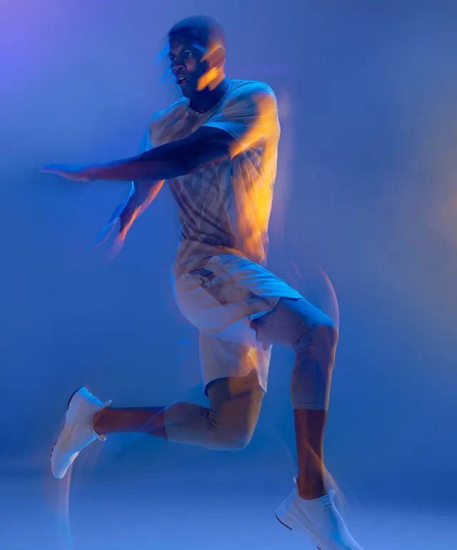 Dynamic Athlete in Blue Lighting