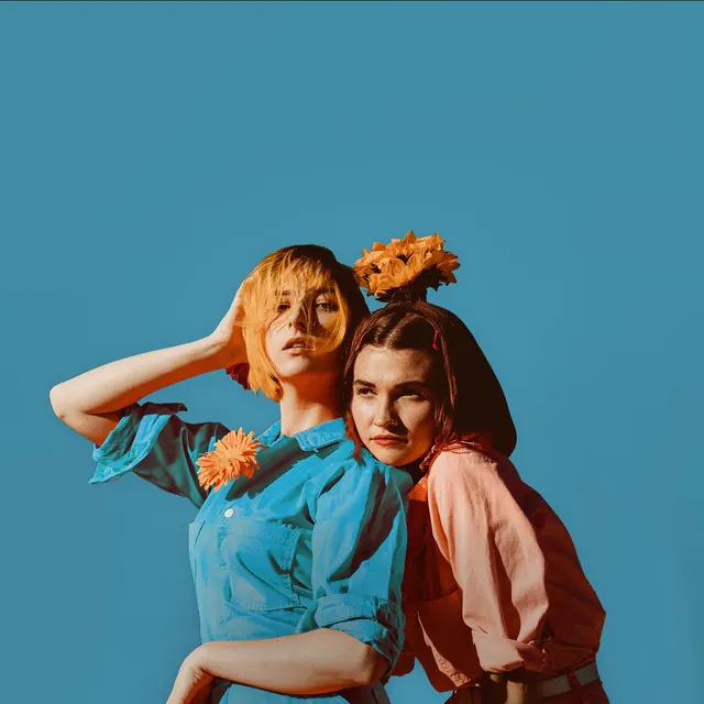 Two women with orange flowers