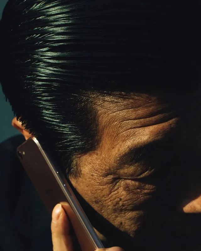 Close-up Portrait of Man with Smartphone