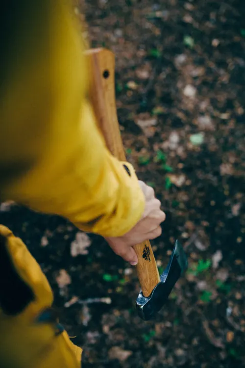Person in Yellow Jacket Holding Object