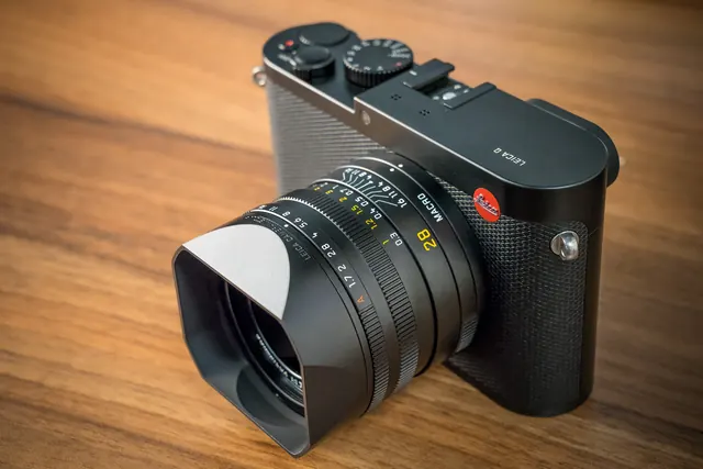 Leica Q camera on wood, minimal, technical, dark