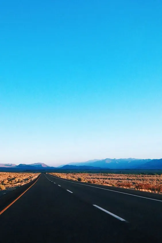Desert highway under blue sky, minimal, photographic, light