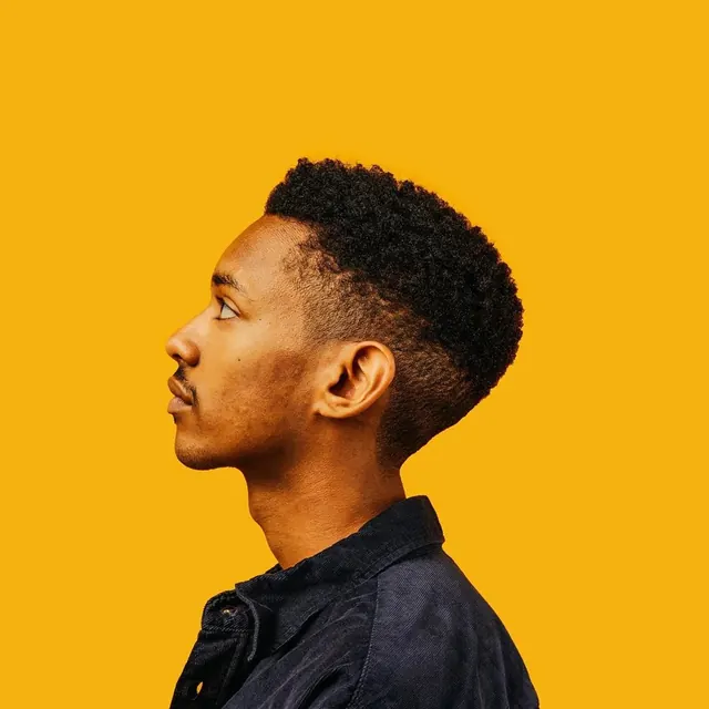 Portrait of a man against yellow background