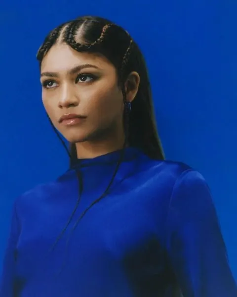 Studio portrait in solid blue, minimal, photographic, vibrant