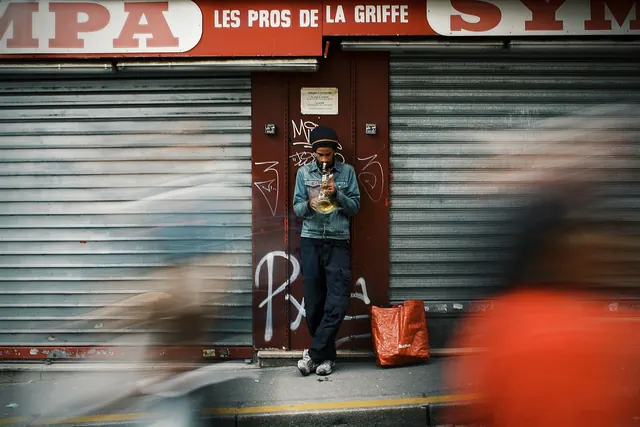Street musician with brass instrument, photographic, muted