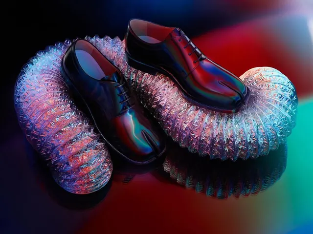 Glossy black tabi shoes on metallic hose, minimal, photographic, dark