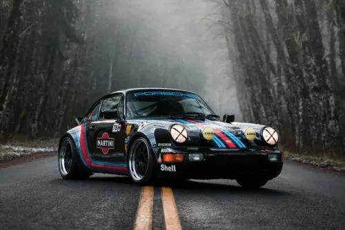 Vintage Rally Car in Foggy Forest