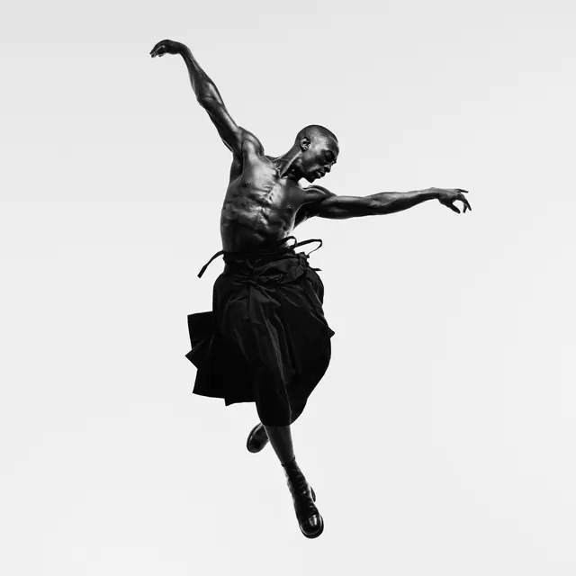 Dynamic black and white dancer mid-leap, monochrome, minimal, monochrome