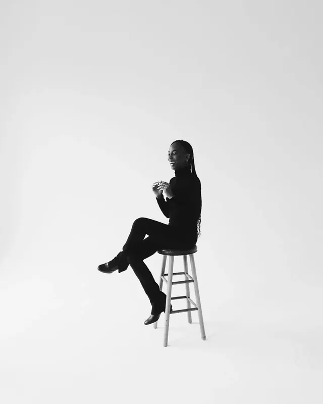 Monochrome Portrait of a Person on a Stool