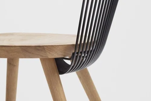 Minimalist oak chair with black rod back, minimal, photographic, light