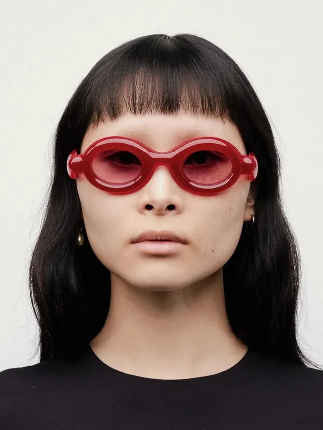 Red oval sunglasses fashion portrait, minimal, editorial, dark