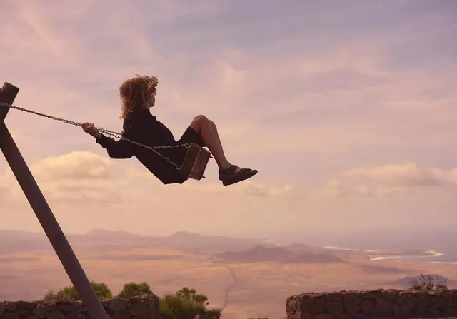 Person on Swing Over Canyon