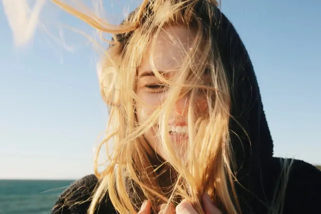 Woman with Wind-Swept Hair on Beach