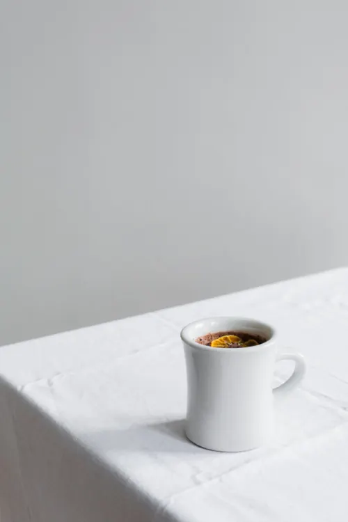 Minimalist Coffee Cup on White Linen