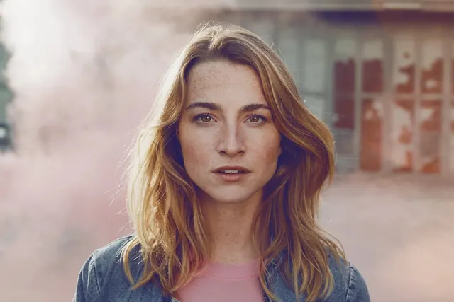 Portrait of a woman in denim and pink
