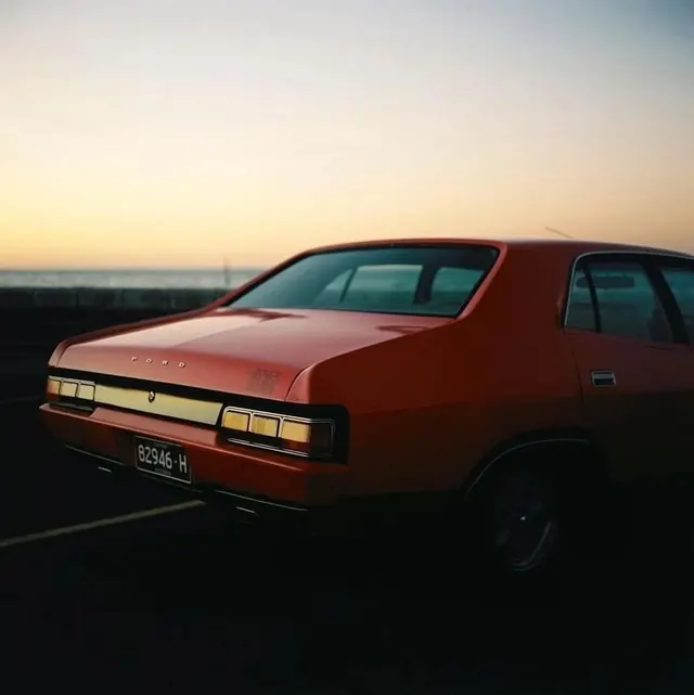 Vintage Orange Sedan at Sunset