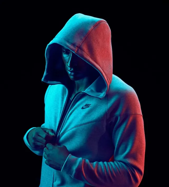 Hooded Figure in Dual-Tone Lighting