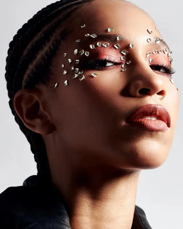 Rhinestone eye makeup close-up portrait, photographic, editorial, warm