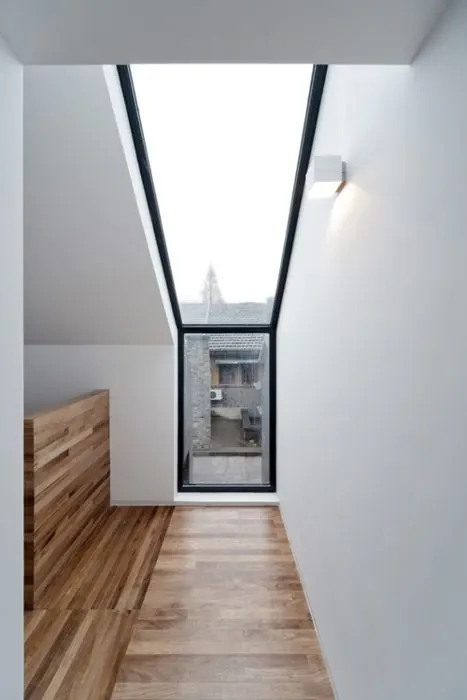 Minimal modern hallway with skylight and wood accents, minimal, photographic, light