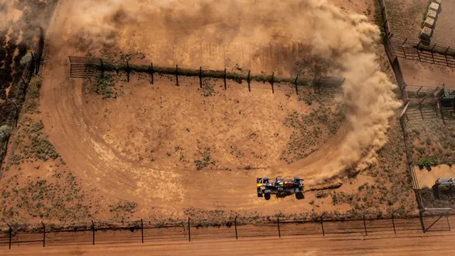 F1 car dust trail aerial photo, photographic, technical, earthy