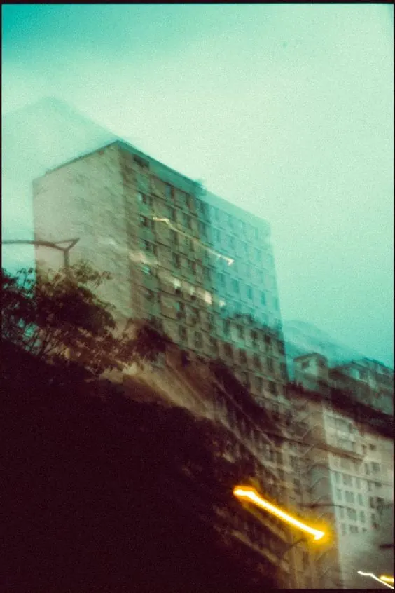 Motion-blur apartment building at night, photographic, abstract, cool