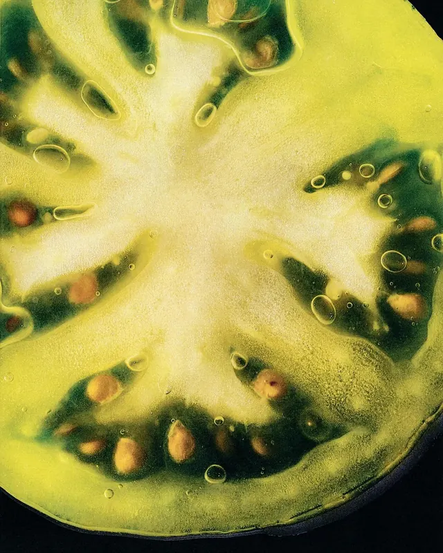 Green tomato cross-section macro, photographic, organic, vibrant