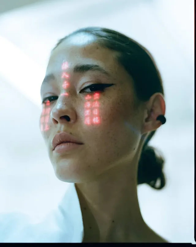 Cyberpunk portrait with red projected text, editorial, photographic, light