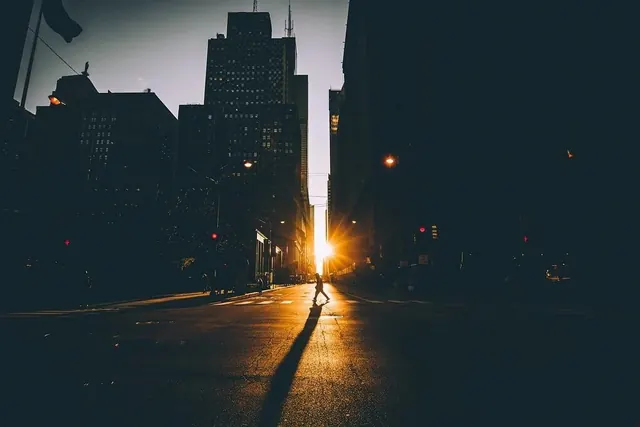 Manhattanhenge street silhouette at sunset, photographic, editorial, dark