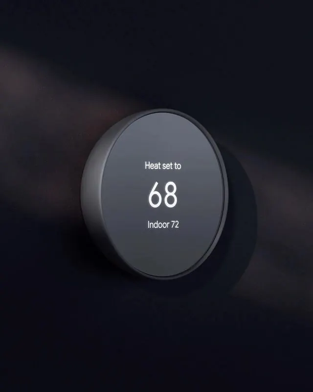 Nest-style smart thermostat on dark wall, minimal, technical, dark