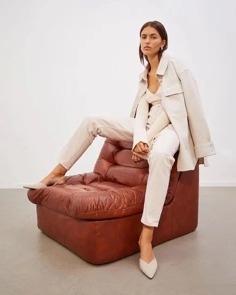 Cream tonal outfit on cognac Togo chair, minimal, editorial, light