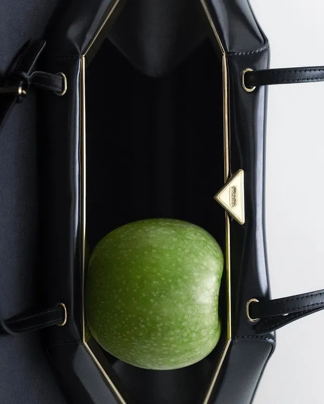 Prada bag with green apple, minimal, luxury, dark
