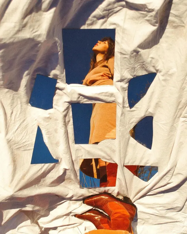 Cutout sheet frames model against sky, photographic, editorial, light