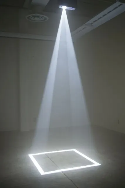 Projector draws glowing square on floor, minimal, photographic, monochrome
