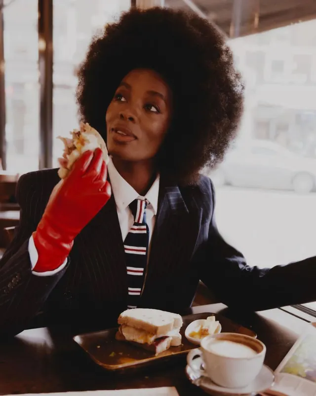 Fashion editorial portrait at cafe with red gloves, editorial, photographic, warm