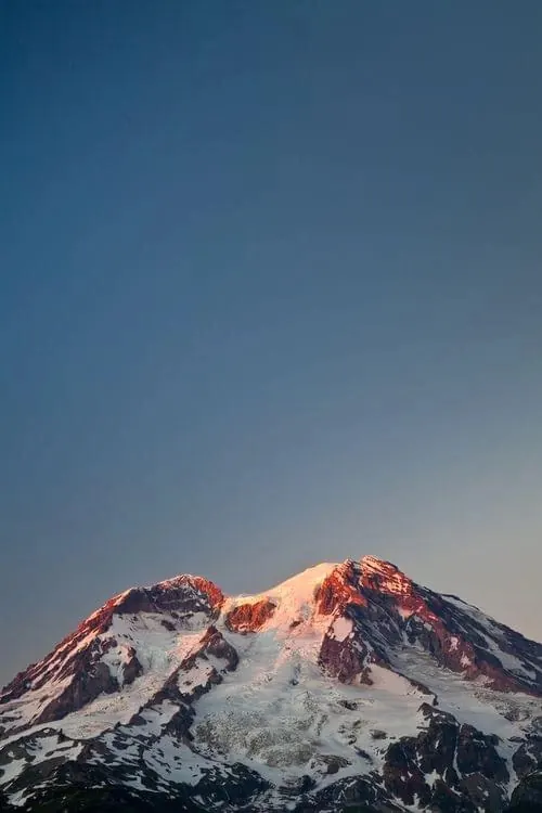 Snow capped mountain alpenglow landscape, photographic, minimal, cool