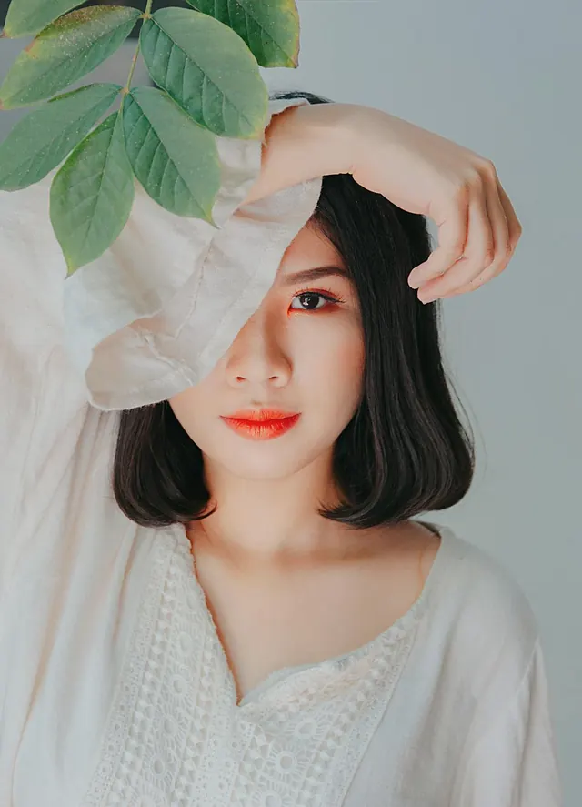 Portrait of a woman with leaf and fabric