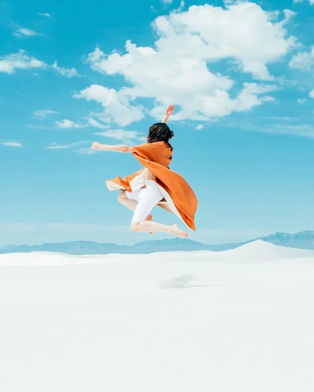 Woman Jumping in Snowy Landscape