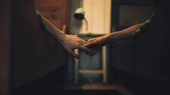 Hands Reaching Through Doorway