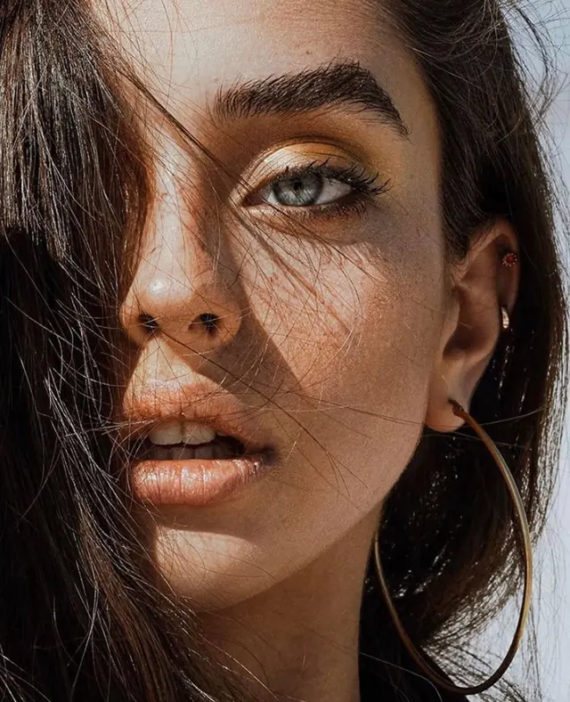 Dramatic closeup beauty portrait with side light, editorial, photographic, warm