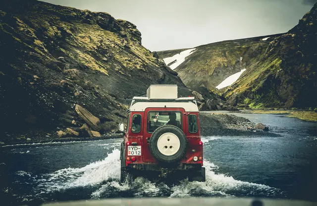 Red Van in Snowy Mountain Landscape