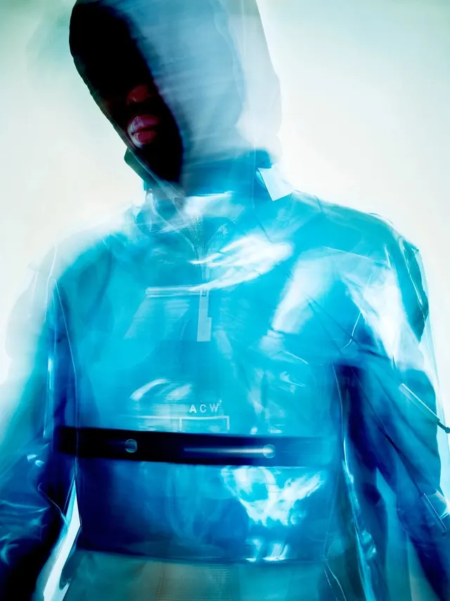 Motion-blurred translucent blue hooded jacket, photographic, editorial, vibrant