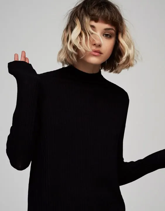 Portrait of a woman in a black turtleneck
