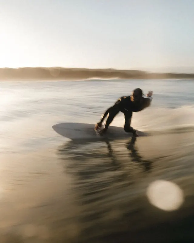 Surfer on a Wave at Sunset