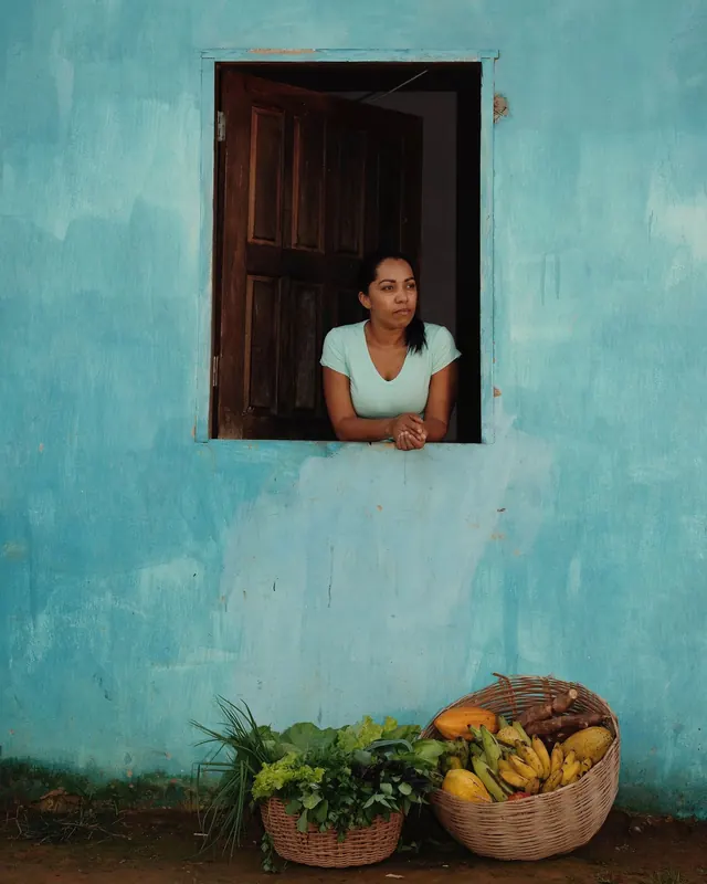 Woman in Blue Window with Produce