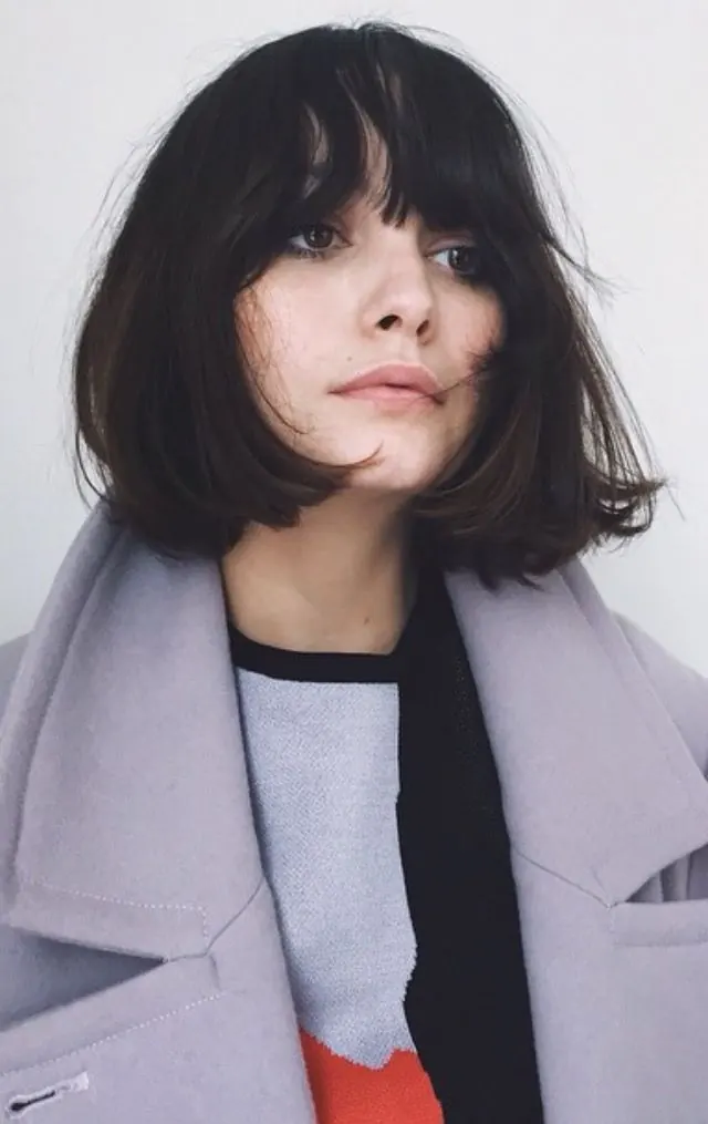 Portrait of a woman in a lavender coat