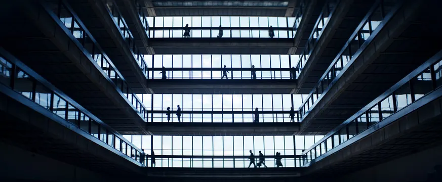 Brutalist multi-level atrium with silhouetted figures, minimal, editorial, dark