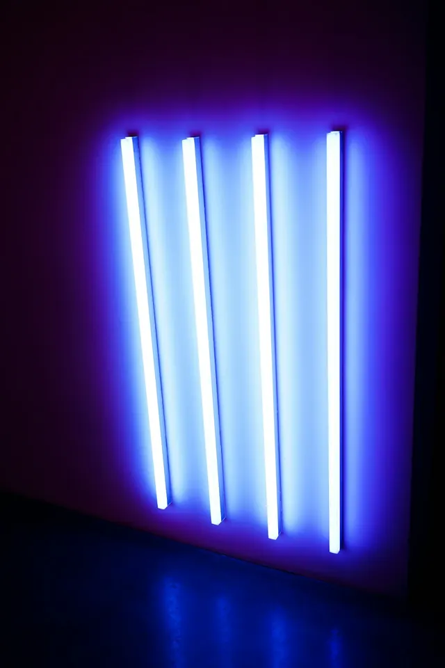Five vertical glowing blue neon tubes, minimal, geometric, dark